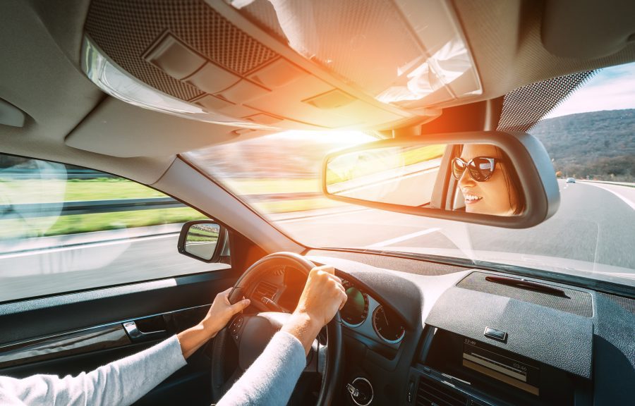 Woman,Drive,A,Car,Reflects,In,Back,View,Mirror